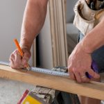 Man measuring a board.