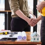 Person shaking hands with a general contractor