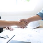 Shaking hands with a bonded and insured contractor