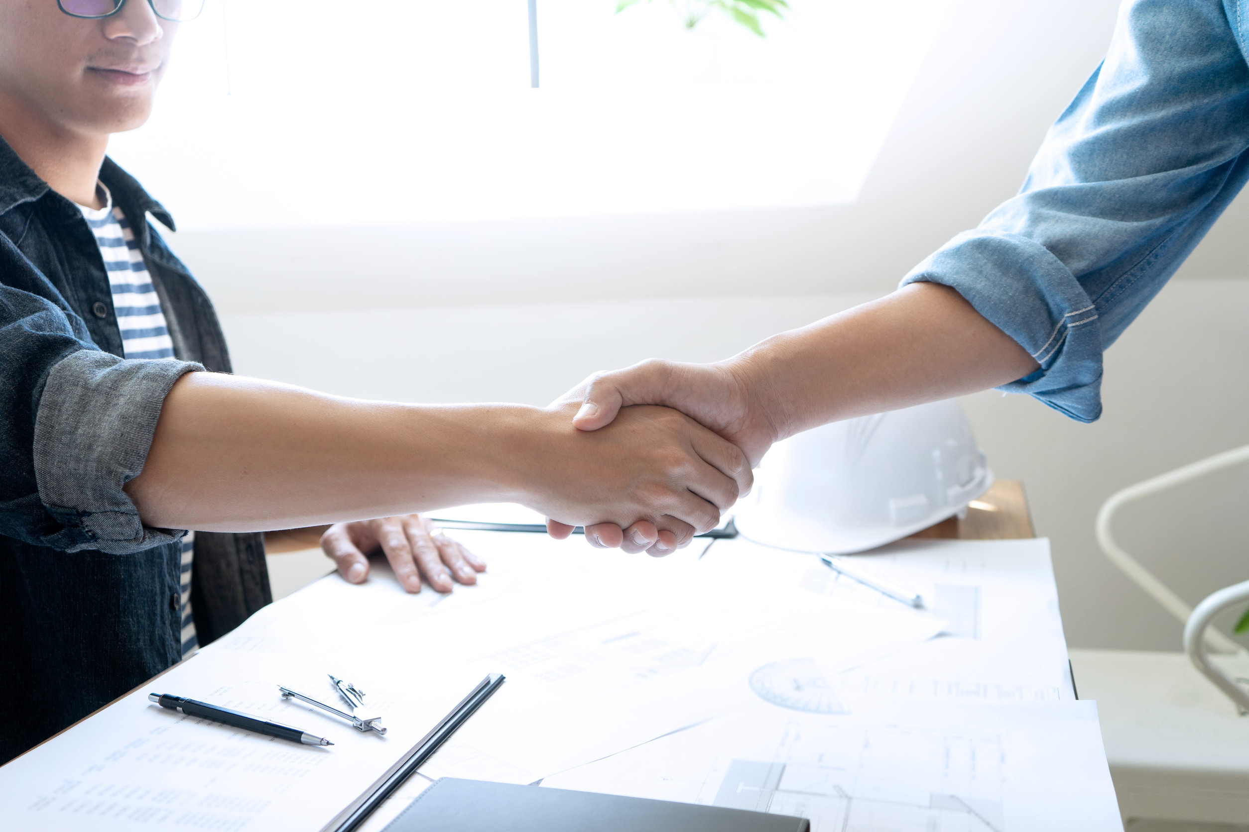 Shaking hands with a bonded and insured contractor