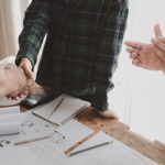 Homeowner shaking hands with a contractor