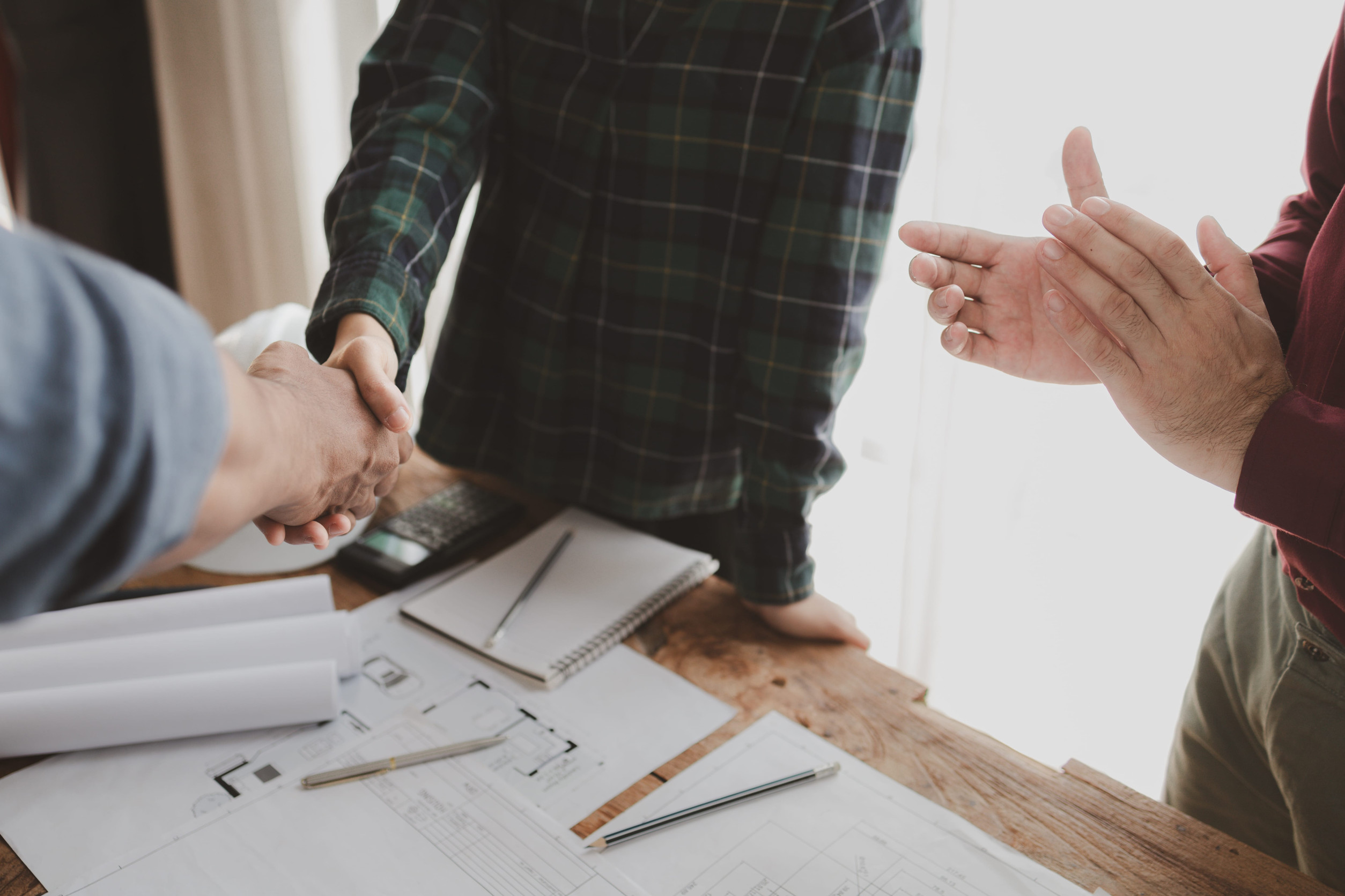 Homeowner shaking hands with a contractor